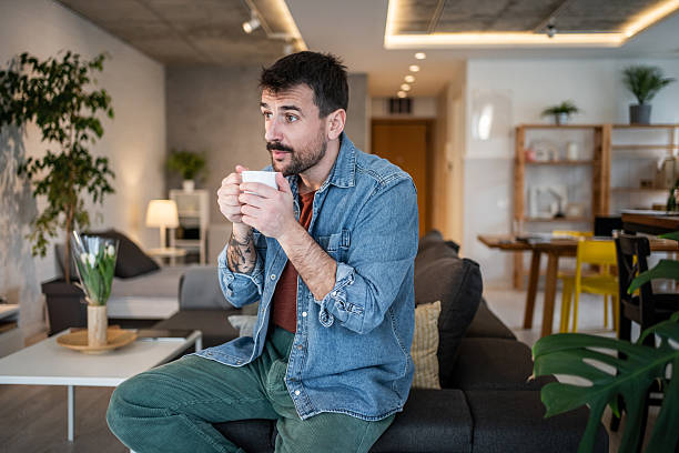 istock Young man relaxing with coffee at home 2239766094