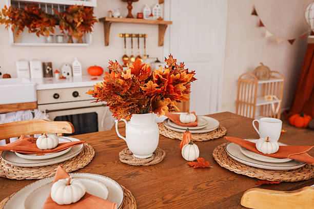 istock Cozy autumn dining setting with pumpkins and fall decorations in a warm kitchen 2239767904