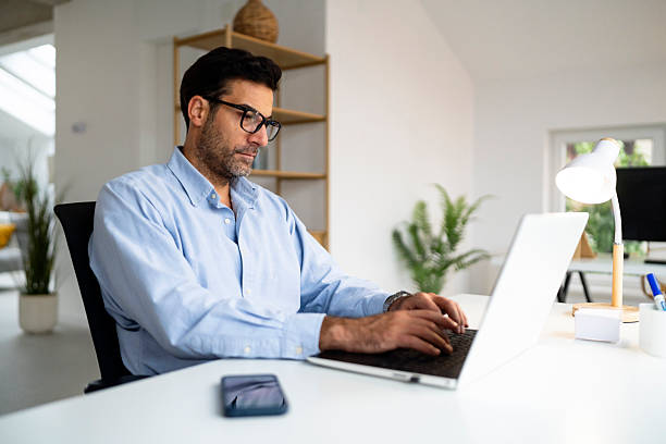 istock A businessman typing on his laptop in a modern office 2239768164