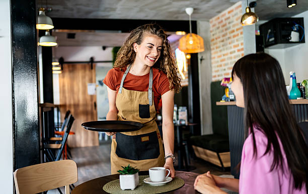 istock Waitress serving coffee to customer in cafe 2239768321