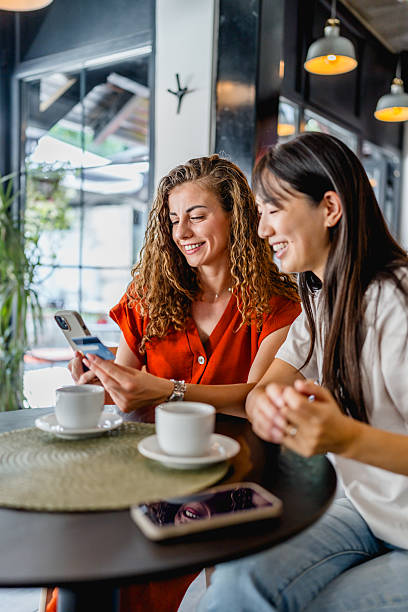 istock Women friends making online payment using credit card 2239769150