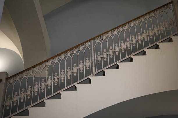 An elegantly designed staircase featuring a unique railing and incorporating modern architectural elements beautifully