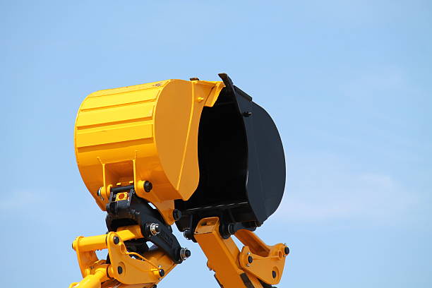 Yellow and Black Bucket Shovels of Two Excavators.