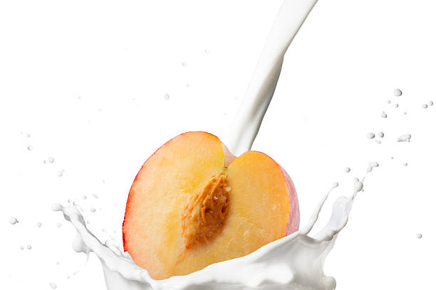 istock Milk Pour on Milk Splash With Peach Fruits 2239775577