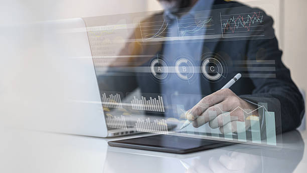 istock Businessman using laptop and tablet analyzing economic data and sales growth on financial charts 2239784036
