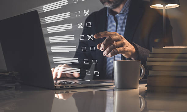 istock Man do online exam on virtual screen. Answer a survey filling out a tech form. Quiz, test concept 2239784058