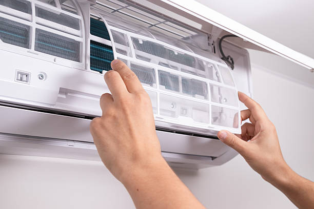 istock Close up of man inserting new filter into air conditioner unit during regular maintenance. Concept of HVAC service, home care, clean indoor air, and energy-efficient cooling. 2239785867