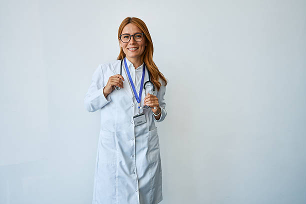 istock Female doctor smiling wearing stethoscope and white coat 2239786345