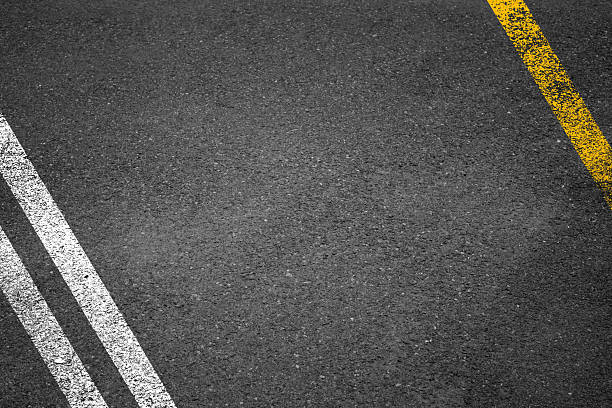 istock White And Yellow Stripes On Asphalt Road Texture. 2239786824