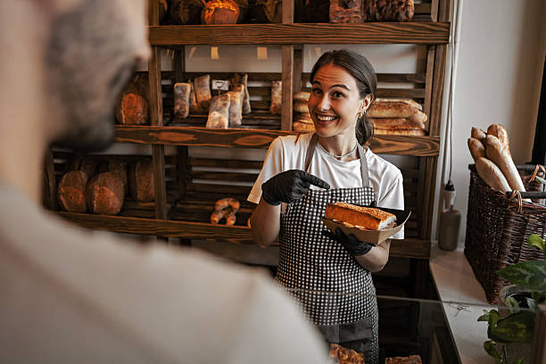 istock Young Lady Holding Sandwich and Smiling Indoors 2239786922