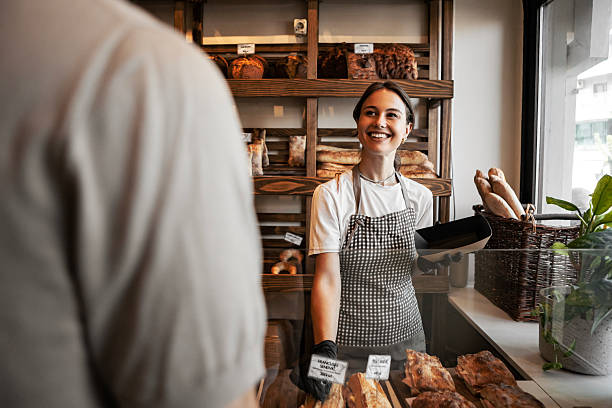 istock Smiling Woman in Bakery Holding Fresh Sandwich 2239786941