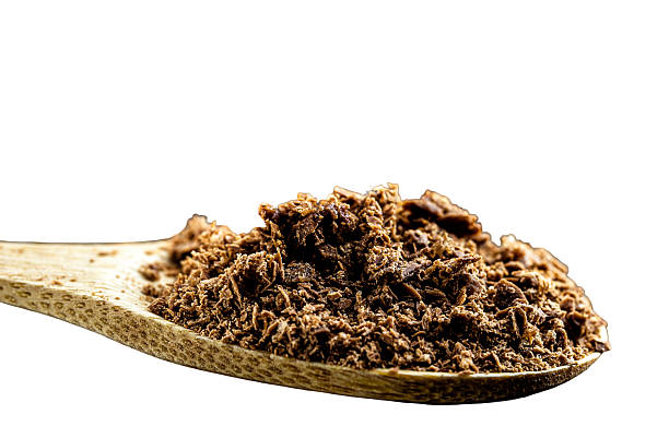 istock granulated chocolate powder in rustic wooden spoon with copy space on isolated white background. 2239790102