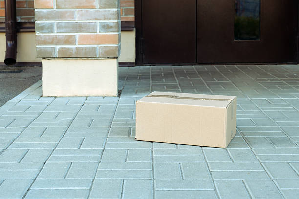 istock Cardboard package box delivered on house porch 2239795041