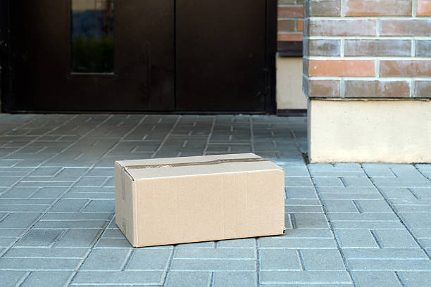 istock Cardboard package receiving a home doorstep delivery 2239795145