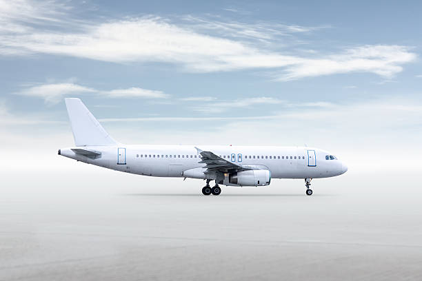 istock White passenger airliner isolated on bright background with sky 2239795698