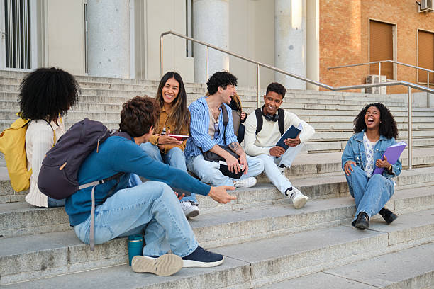 istock Diverse students laughing and talking on university campus stairs 2239796718