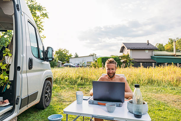istock Man Working Remotely at a Scenic Van Campsite 2239796768