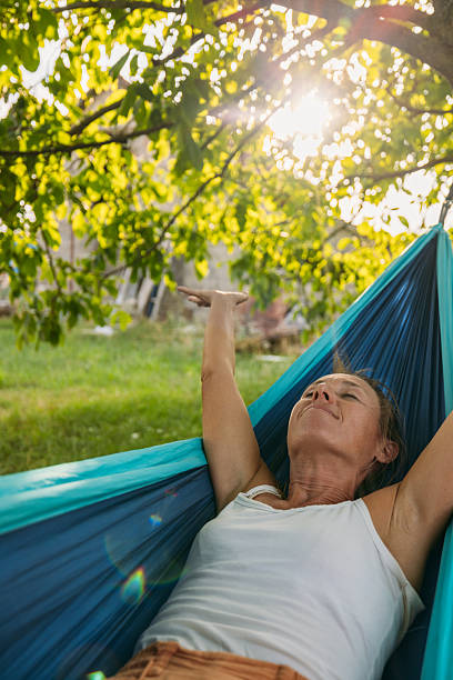 istock Woman Relaxing in Hammock Outdoors on Sunny Day 2239796785