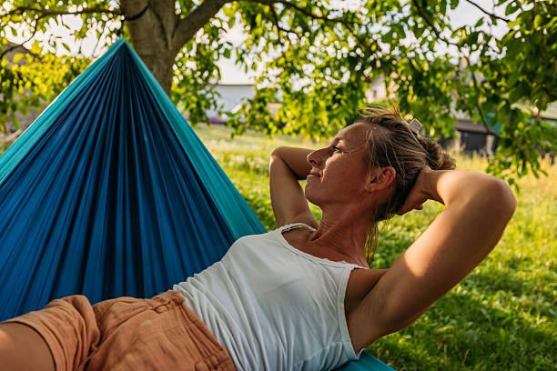 istock Woman Relaxing in Hammock Outdoors on Sunny Day 2239796858