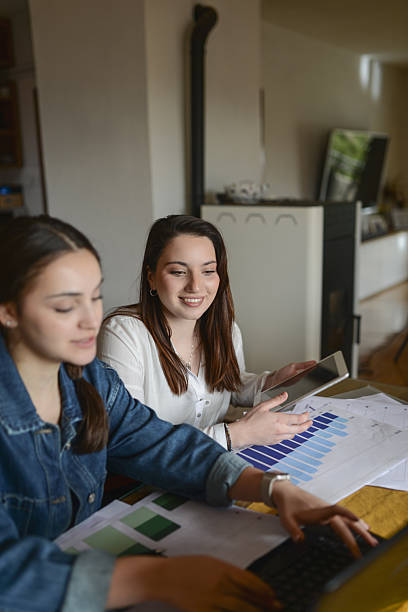 istock Two Friends Working Together On Data Charts And Tablet In Modern Home Office 2239798373
