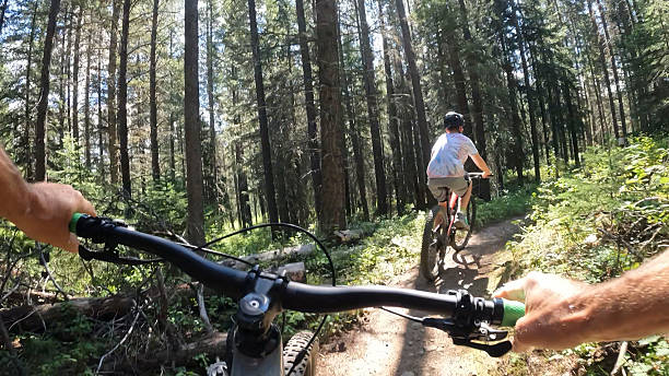 istock POV from bike handlebars to boy riding bicycle in forest 2239798824