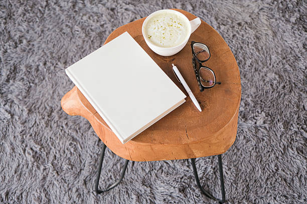 istock blank book mockup on white coffee table with green matcha tea near window 2239799892
