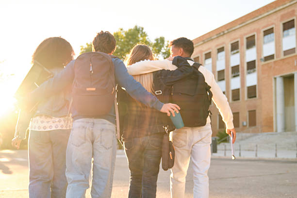 istock Diverse students walking on campus showing friendship at sunset 2239801423