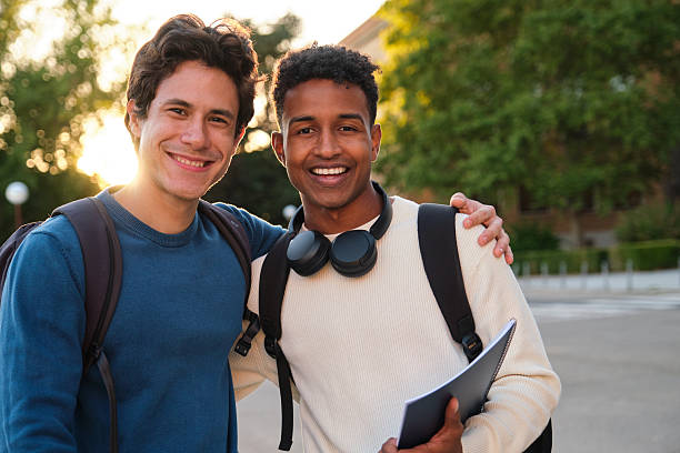 istock Diverse male students smiling outdoors on university campus 2239803810