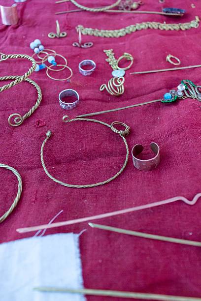 istock Handmade jewelry creation process on a red textile background with various tools and materials 2239804323