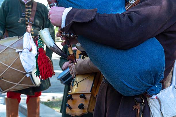 Calgary, Alberta, Canada. Nov 11, 2025. Close-up Premier snare drum on pavement surrounded by kilted marchers wearing red and white argyle hose and black shoes.