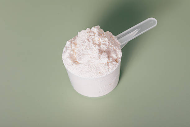 istock Scoop of powdered substance is sitting on a green surface 2239804759