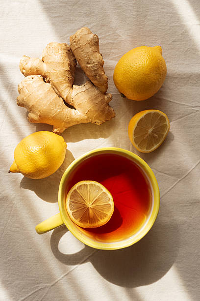 istock Flat Lay with Lemon Tea, Ginger and Honey on Light Table under Sun Light 2239807844