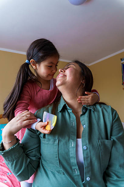 istock Mother and daughter smiling while embracing 2239808006