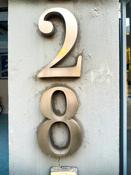 istock Metal building number 28 attached on granite wall 2239808329