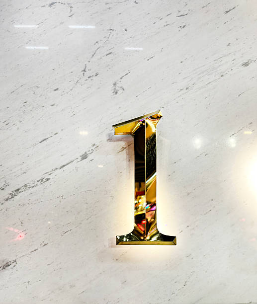 A close-up of a silver table number stand featuring the number \