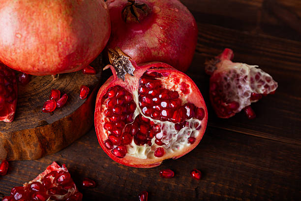 istock Fresh pomegranate on the wooden table close up 2239810695
