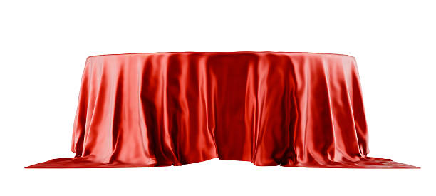 istock red silk cloth draped over podium, white background 2239811445
