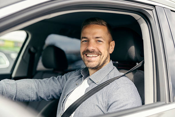 istock Happy man driving car with seat belt on 2239811586