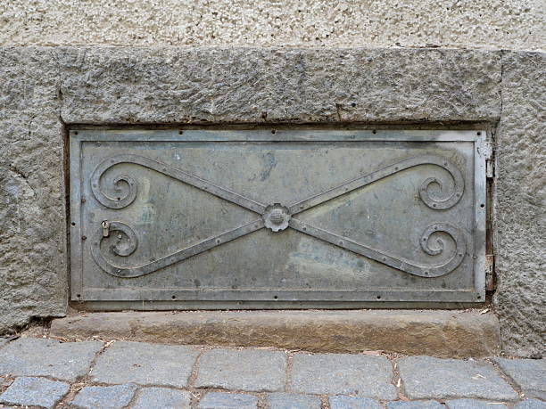 istock Cellar window with ornamental grille in stone wall 2239811590