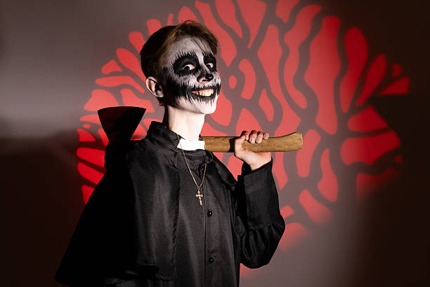 a young guy dressed up in a Halloween costume with an axe