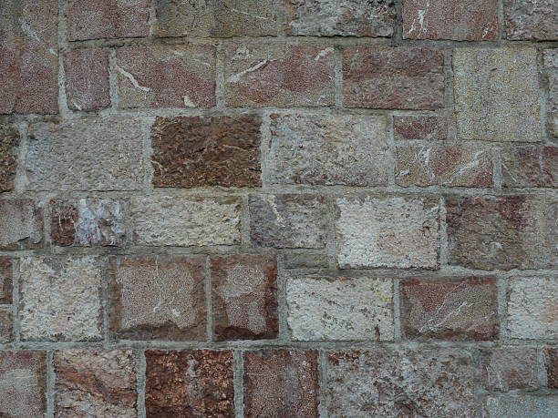 Irregular natural stone masonry with varying colors, textures and joints.