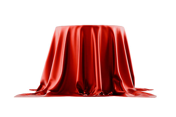 istock red silk cloth draped over podium, white background 2239811717