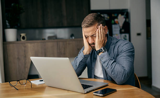 istock Stressed businessman suffering from headache working from home 2239811723
