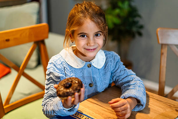 Girl eating a donut at home
