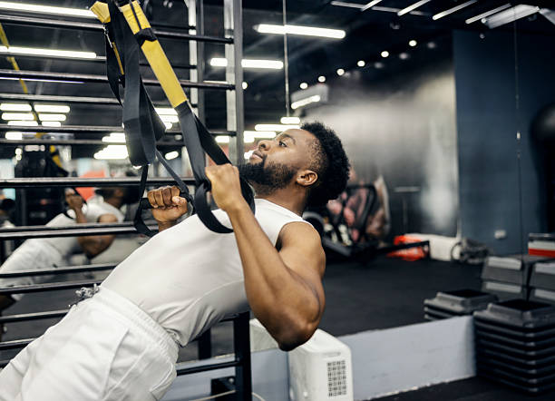 istock Man doing suspension training workout in gym 2239816598