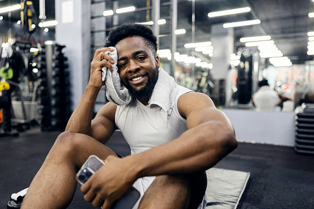 istock Happy man resting in gym after workout 2239816642