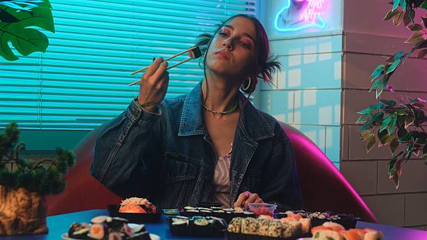 istock Young Woman Enjoying Sushi in a Retro Diner Setting 2239818144