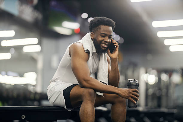 istock Man taking phone call during gym workout break 2239818322
