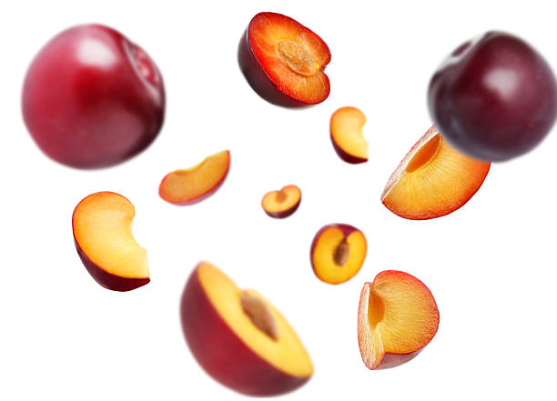 istock Fresh ripe plums swirling in air against white background 2239818334