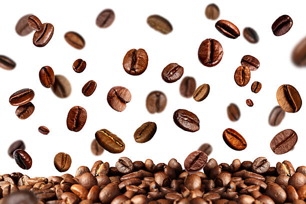 istock Roasted coffee beans falling onto heap against white background 2239819617